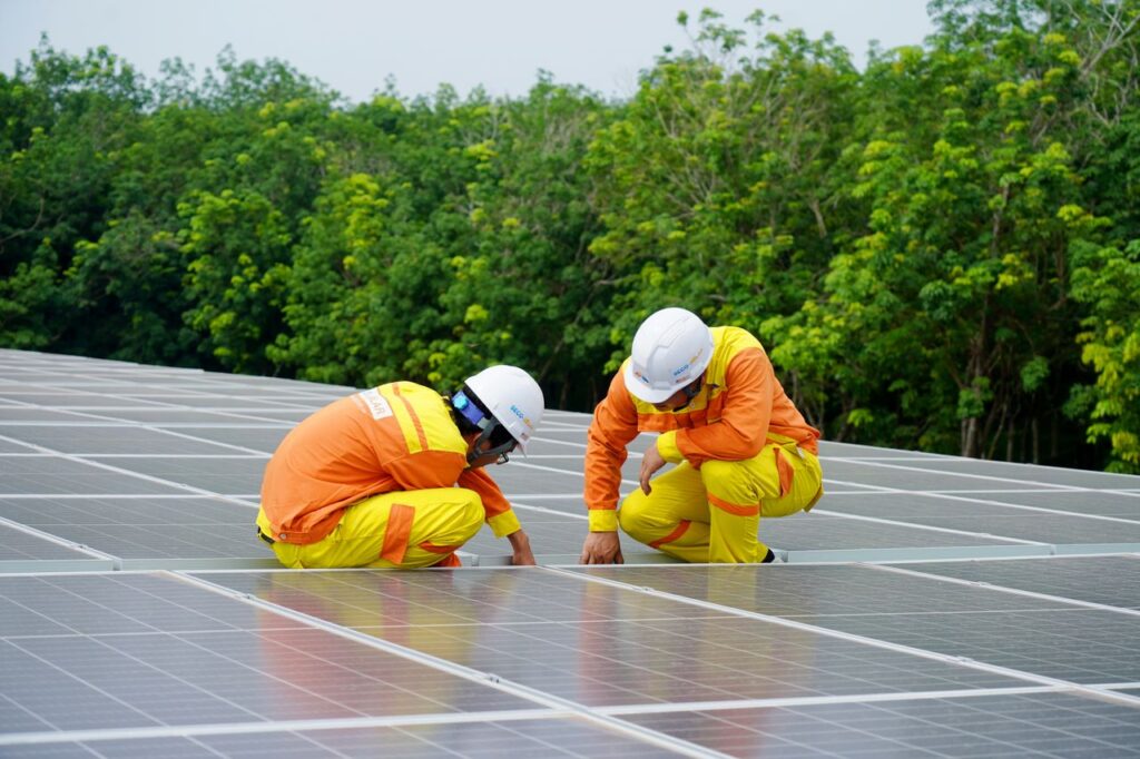 Crafting Captivating Headlines: Your awesome post title goes here Workers installing photovoltaic solar panels on a sunny day, promoting renewable energy.